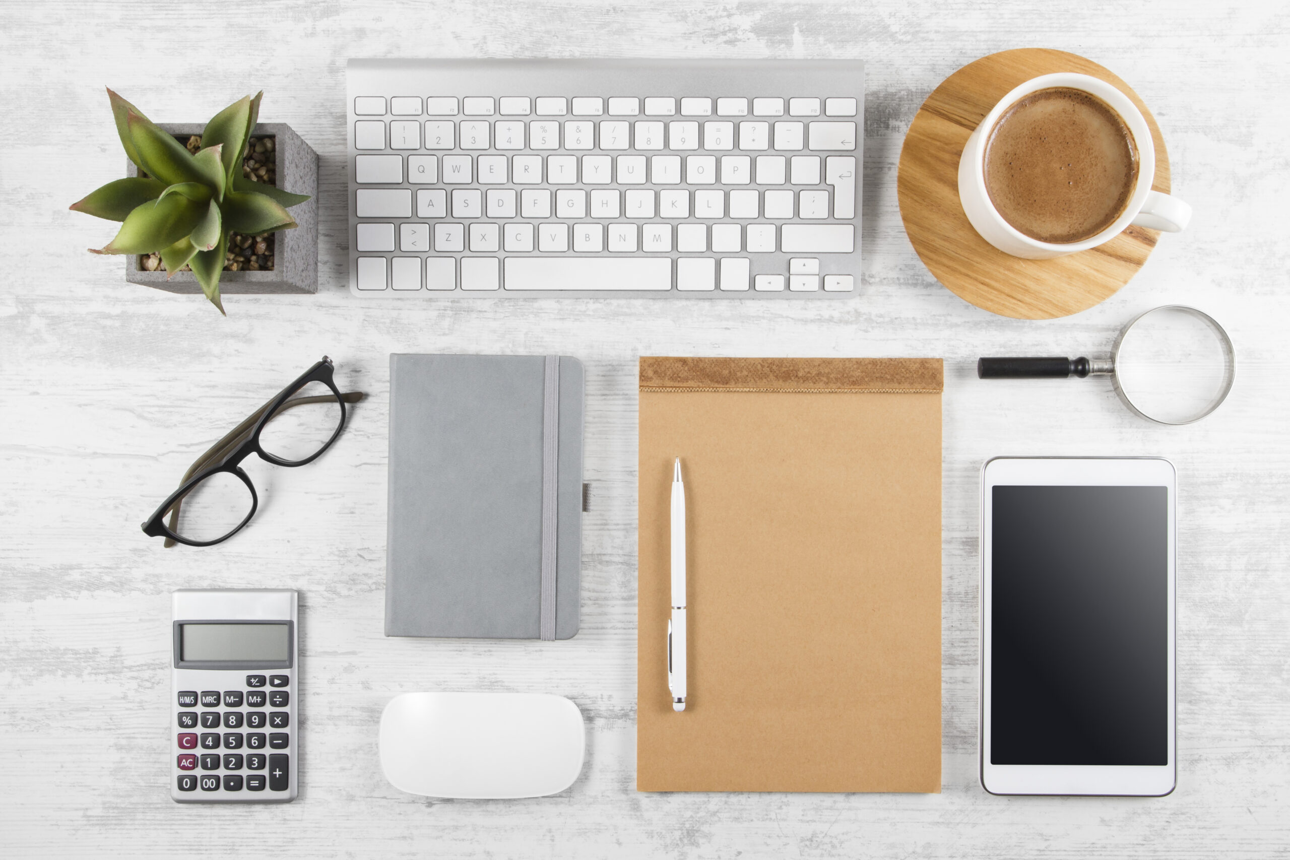 Business table top with office supplies on white wooden table background